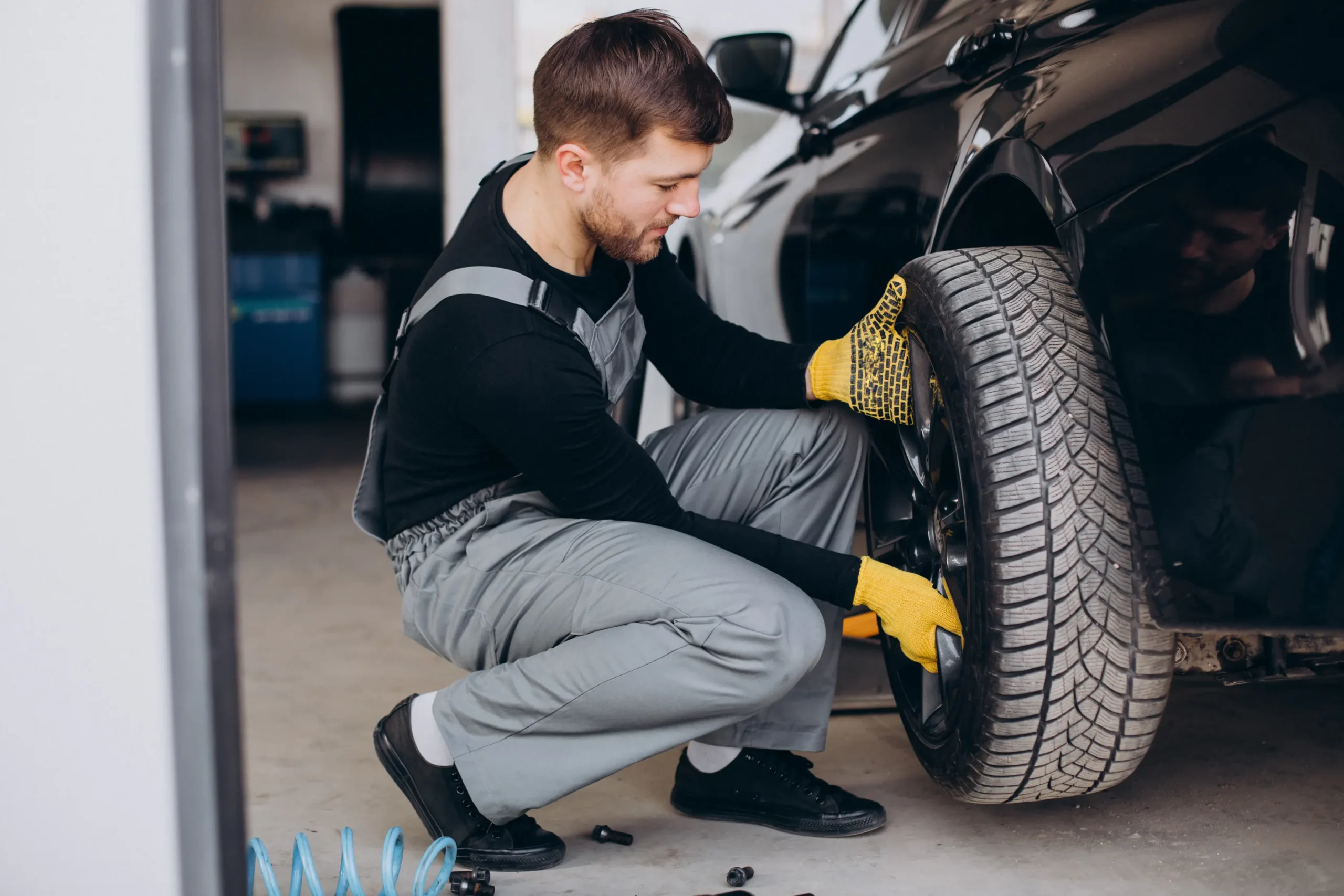 A professional from aone roadside assistance doing tyre replacement service